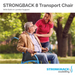 An elderly man sits in a Strongback Mobility Excursion 8 Transport Wheelchair, weighing just 19 lbs and featuring built-in lumbar support. A smiling caregiver places a hand on his shoulder as they enjoy the parks serene setting, benefiting from the chairs foldable design for easy mobility among the trees.