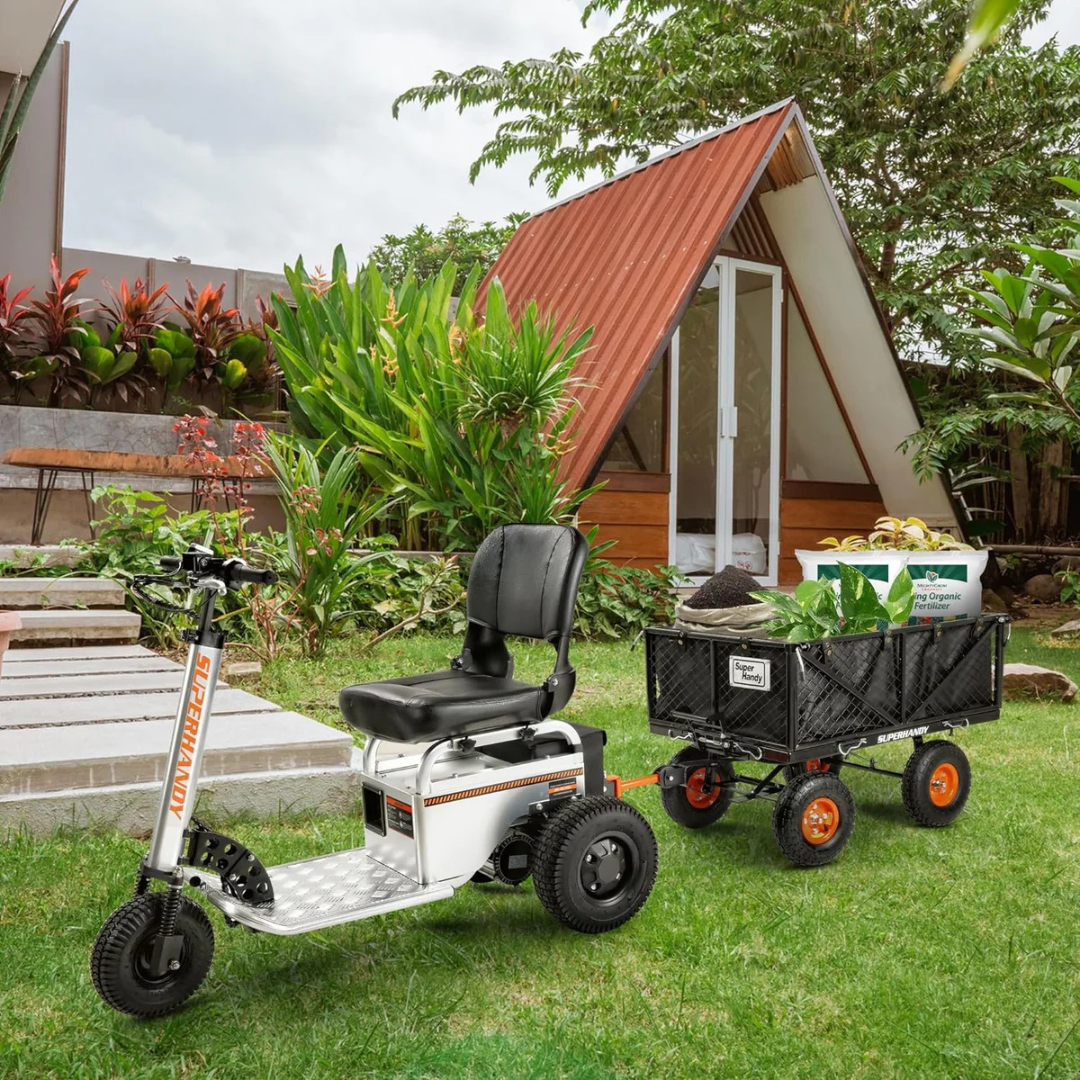A three-wheeled mobility scooter with a black seat tows a SuperHandy Towable Garden Cart - Quick Dump System full of gardening supplies across a lawn, passing by a modern triangular cabin surrounded by plants.