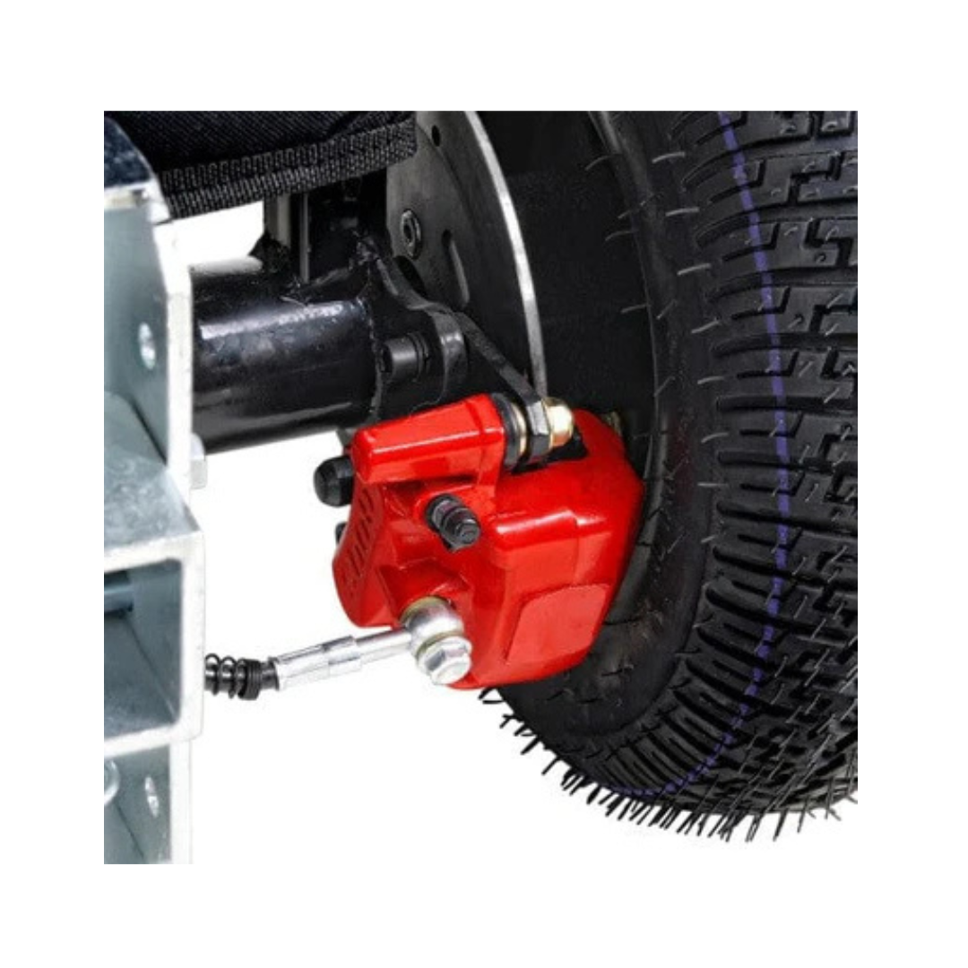 Close-up of a black rubber tire with visible tread, mounted on the SuperHandy Tugger Tow Tractor - Powerful Towing Scooter, featuring a bright red disc brake caliper on the wheel assembly.
