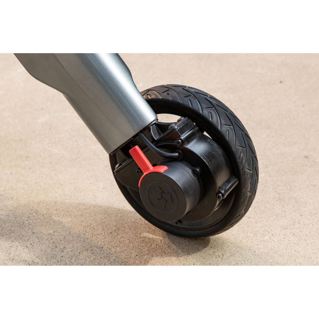 Close-up of a black Superpi W1 Electric Wheelchair Rollator wheel, featuring a red brake lever on light concrete—showcasing the innovative 4-in-1 design found in modern mobility devices.