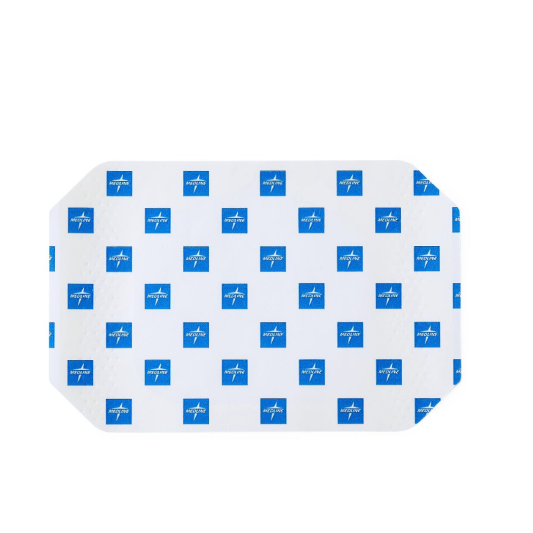 The Medline SureSite Window Transparent Film Dressing is a rectangular adhesive patch with rounded corners for catheter site protection, covered by a white backing with small blue squares that have a white cross and text.