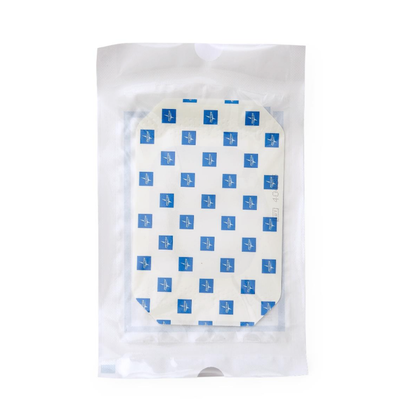 The Medline SureSite Window Transparent Film Dressing is a sealed, clear pouch containing a white rectangular adhesive bandage with blue squares, made for IV or catheter site protection, shown against a plain white background.