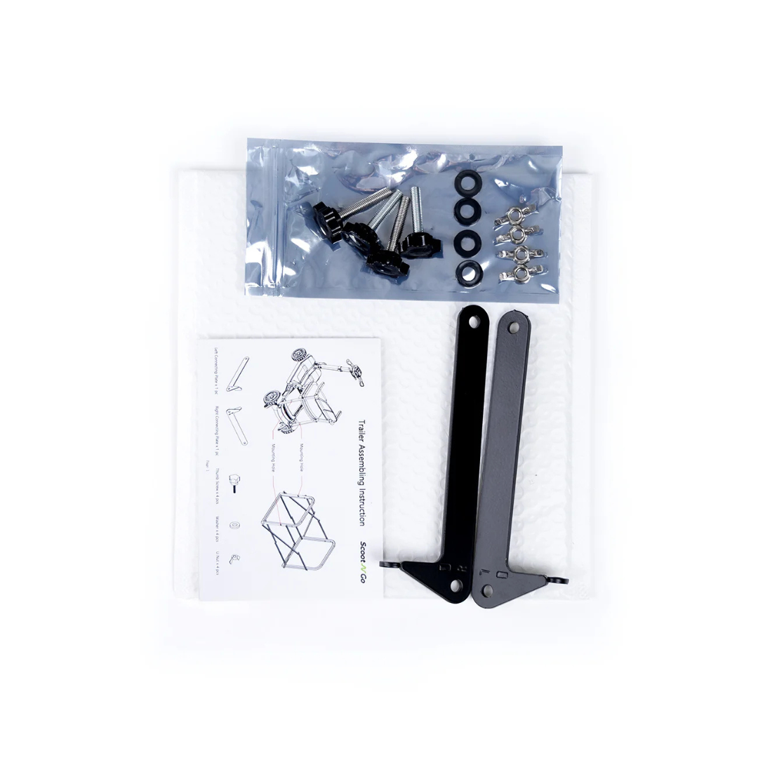 A package for the Trailer For ScootNgo Lite/Voyager includes metal brackets, screws, washers, clips, and instruction sheets—all neatly arranged on a white padded surface—making it ideal for assembling your Voyager or ScootNgo Lite trailer.