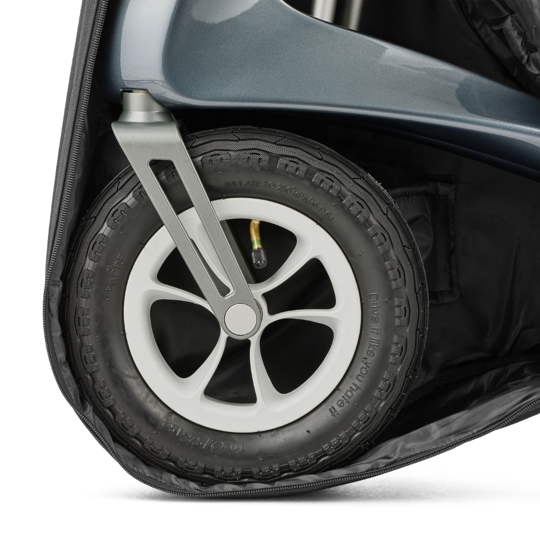 Close-up of a black wheel with a silver five-spoke rim on a gray frame, partially enclosed in the Travel Storage Bag for ByAcre Overland Carbon Fiber Rollator—a custom-fit accessory bag.