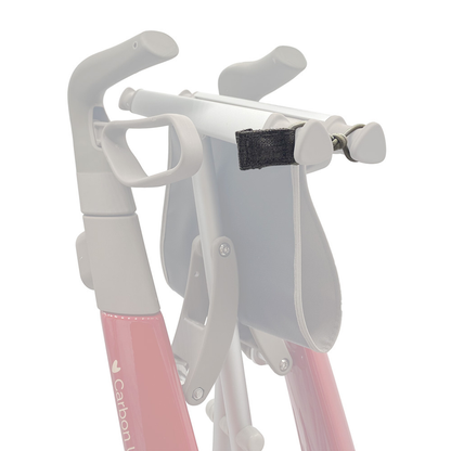 Close-up of a folded byACRE Carbon Ultralight Rollator, showing a strap with hook-and-loop fastener securing the frame—perfect for attaching rollator maintenance accessories or Spare Parts - byAcre Carbon Ultralight Rollator.