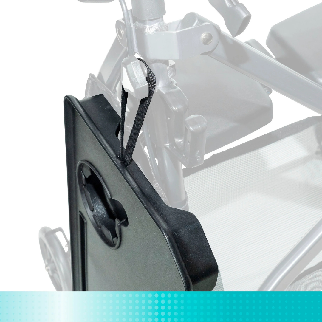 A close-up of the Tray Accessory For Stander Walkers & Rollators in black, featuring a handle and strap, attached to a wheelchair with the wheelchair shown faded in the background—compatible with rollators and Stander walkers.