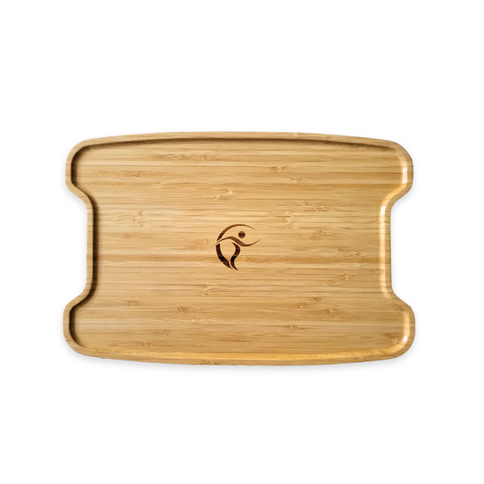 The Triumph Mobility Accessory for Escape Rollators is a rectangular bamboo cutting board with rounded edges, featuring a carved logo of a human figure in motion. It doubles as a bamboo tray, showcasing natural wood grain texture for versatile kitchen use.