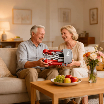 An older man and woman sit smiling on a couch in a cozy living room, holding the Ultra-Compact PackGo Rollator Walker with Backpack | VOCIC Z35 together. A table with fruit and flowers sits in front of them.