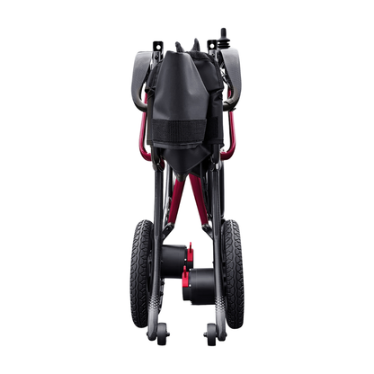 A rear view of the folded Forcemech Ultralite G20 PRO Carbon-Fiber Power Wheelchair in black and red displays its wheels, carbon-fiber frame, and a black storage pouch attached to the back, all set against a white background.