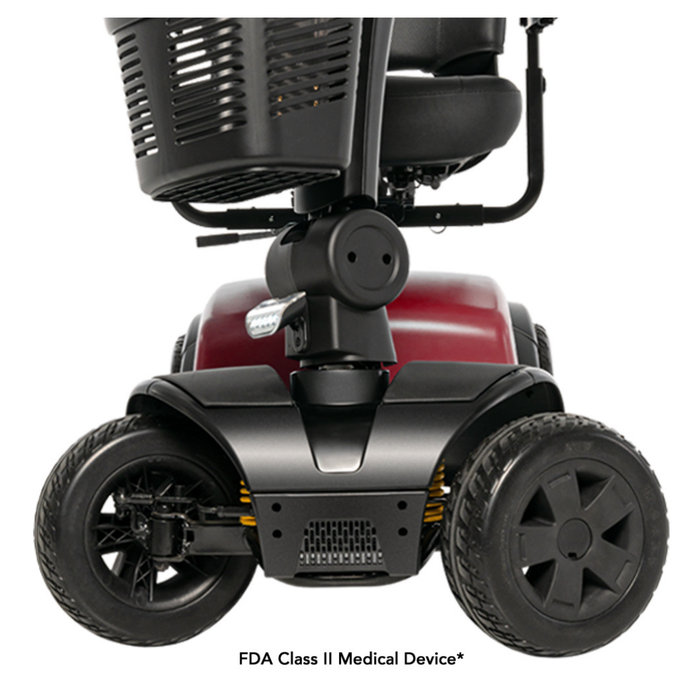 Close-up of the front wheels and base of the Pride Mobility Victory® Platinum Bariatric 4-Wheel Scooter, showcasing EZ Turn technology, a red frame, black tires, a footrest, and partial views of the seat and basket above.
