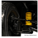 Close-up of a black wheel and suspension system with a bright yellow coil spring, showing mechanical components and EZ Turn Technology on the Pride Mobility Victory® Platinum Bariatric 4-Wheel Scooter. Text at bottom: FDA Class II Medical Device.*.