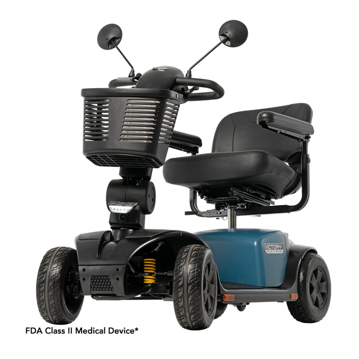 The Pride Mobility Victory® Platinum Bariatric 4-Wheel Scooter features a black cushioned seat, armrests, front basket, rearview mirrors, FDA Class II Medical Device labeling, and EZ Turn Technology for smooth maneuvering.