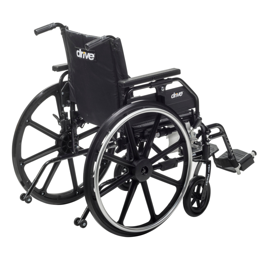 The Drive Viper Plus GT Wheelchair features a lightweight black aluminum frame, Universal Armrests, reclining backrest, large rear wheels, small front wheels, footrests, and a fabric seat and backrest with the drive logo in white. The chair is empty.