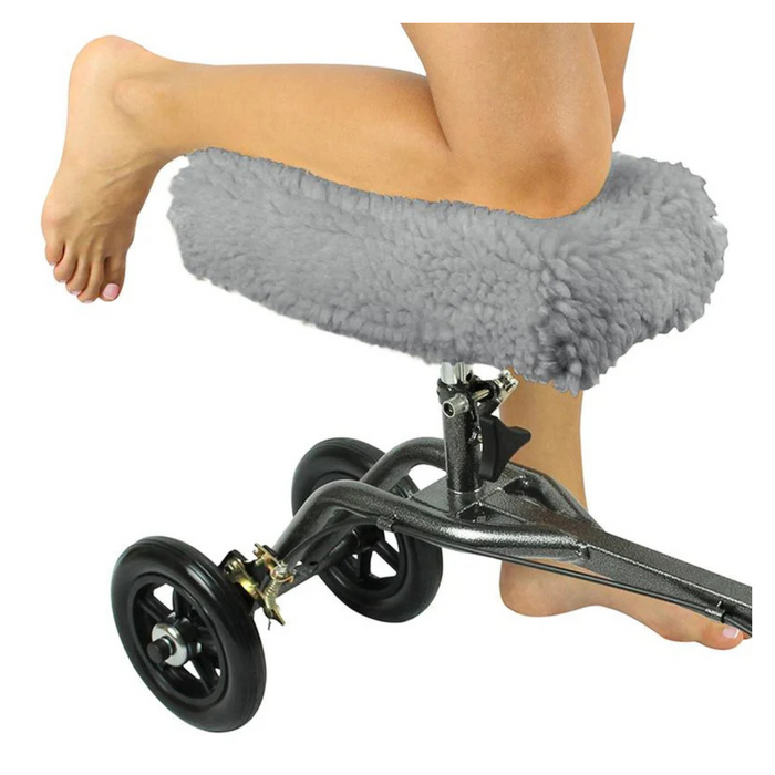 The Vive Health Faux Sheepskin Knee Walker Pad Cover enhances comfort on a knee walker with a gray padded rest. Paired with black wheels and a metallic frame, it supports mobility for individuals with foot or ankle injuries.