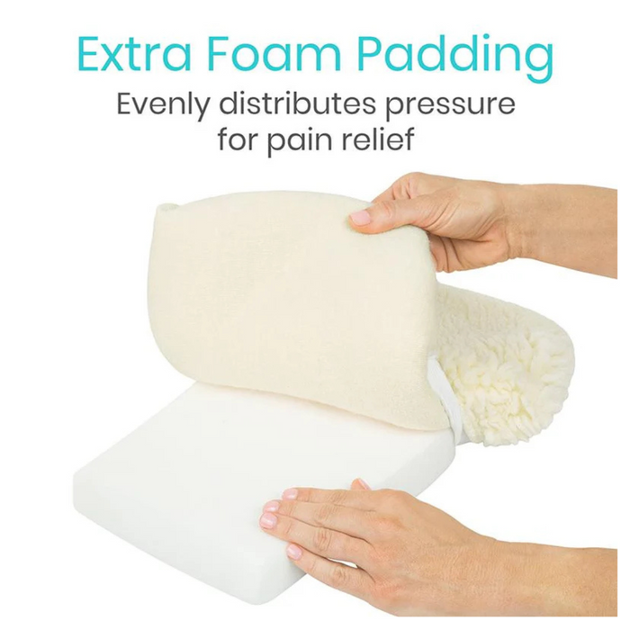 Hands hold foam padding with faux sheepskin cover, showing thickness and texture. Text reads: Vive Health Faux Sheepskin Knee Walker Pad Cover: Extra Foam Padding for even pressure distribution and pain relief. Nonslip design ensures stability for knee walkers.