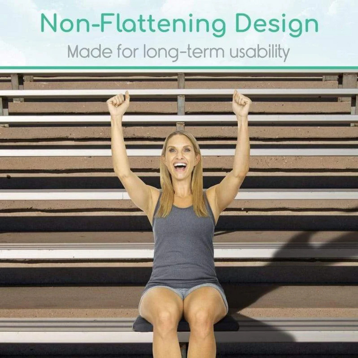 A person with long hair sits on stadium bleachers, smiling with arms raised. The text above reads, Vive Health Honeycomb Gel Seat Cushion: Designed for long-term usability and coccyx pain relief.