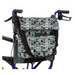 A Vive Health Portable Mobility Bag with a shoulder strap features a black, white, and turquoise geometric arrow pattern. Made from waterproof nylon, it attaches securely to walker handles with adjustable straps and offers ample storage for personal items.