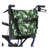 A wheelchair with the Vive Health Portable Mobility Bag, featuring a green and white tropical leaf pattern made of waterproof nylon, is attached at the back using adjustable straps. It has black handles and a striking blue frame.