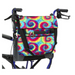 The Vive Health Portable Mobility Bag with Shoulder Strap is a colorful tie-dye pouch for mobility walkers, made from waterproof nylon with vibrant blue, red, and yellow patterns. It includes two external pockets—one for pens and one to hold a small device.