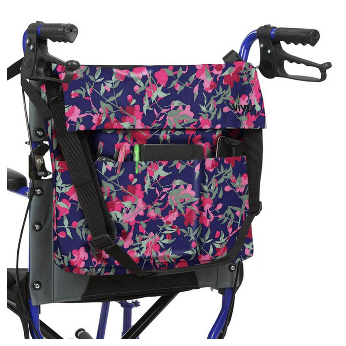 The Vive Health Portable Mobility Bag with Shoulder Strap attaches to a blue walker with black hand grips, featuring a waterproof nylon bag. It displays pink, red, and light green flowers on dark blue, with adjustable straps and pockets for holding a pen, notebook, and phone.