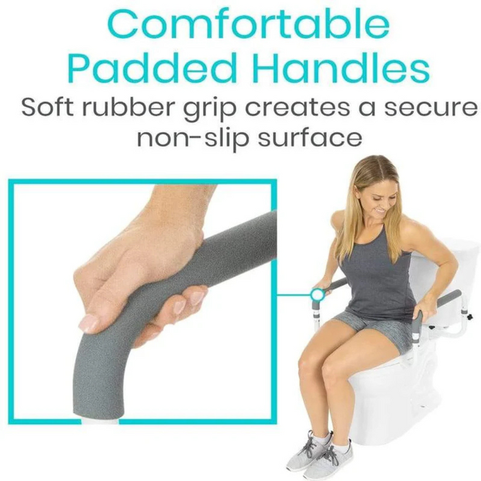 A woman sits on a toilet with the Vive Health Compact Toilet Safety Frame, featuring grey padded handles and adjustable handrails. The inset shows a hand gripping a handle with text above stating, Comfortable Padded Handles. Soft rubber grip ensures safety with a secure, non-slip surface.