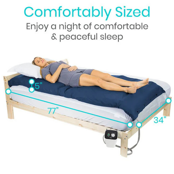 A woman rests on the Vive Health 5 Alternating Pressure Pad—Bedsore Prevention, sized at 77x34x5 inches. Covered in a blue blanket and white sheets, the mattress offers adjustable firmness with alternating air chambers for personalized comfort. Text reads Comfortably Sized.