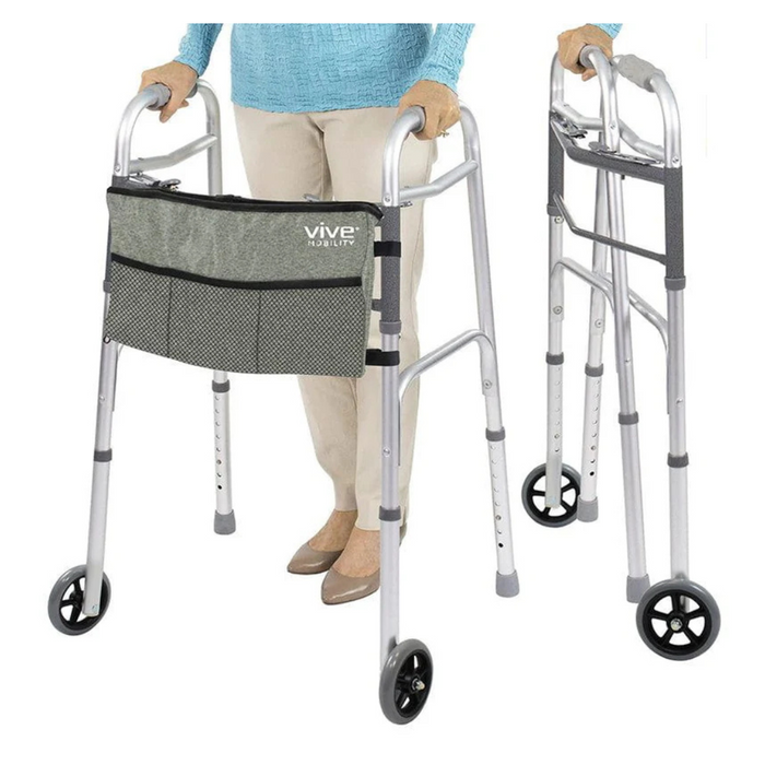 A person in beige pants and a blue top stands behind a Vive Health Folding Walker with 5 wheels, featuring a gray mesh pouch. Another similar foldable walker with black handles and wheels is beside it. Suitable for users up to 66.