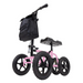 The Vive Health All Terrain Knee Walker is a pink scooter with four black XL 12 treaded tires, a comfy black padded seat, and a handy black storage bag on the handlebars, providing an excellent crutch alternative for seamless mobility.