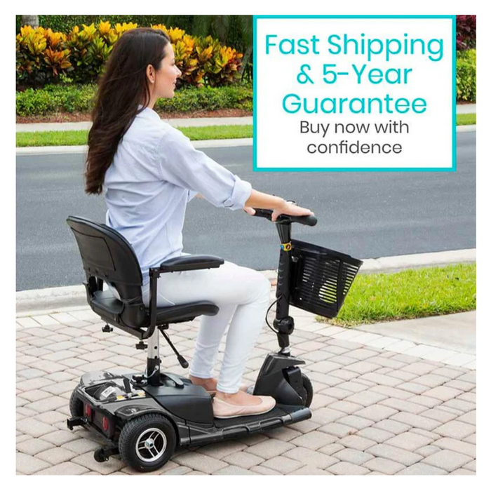 A person in a light blue shirt and white pants relaxes on a Vive Health 3 Wheel Power Mobility Scooter - Long Range. A sign above reads, Fast Shipping & 5-Year Guarantee. Buy now with confidence, highlighting its excellent maneuverability and battery life.