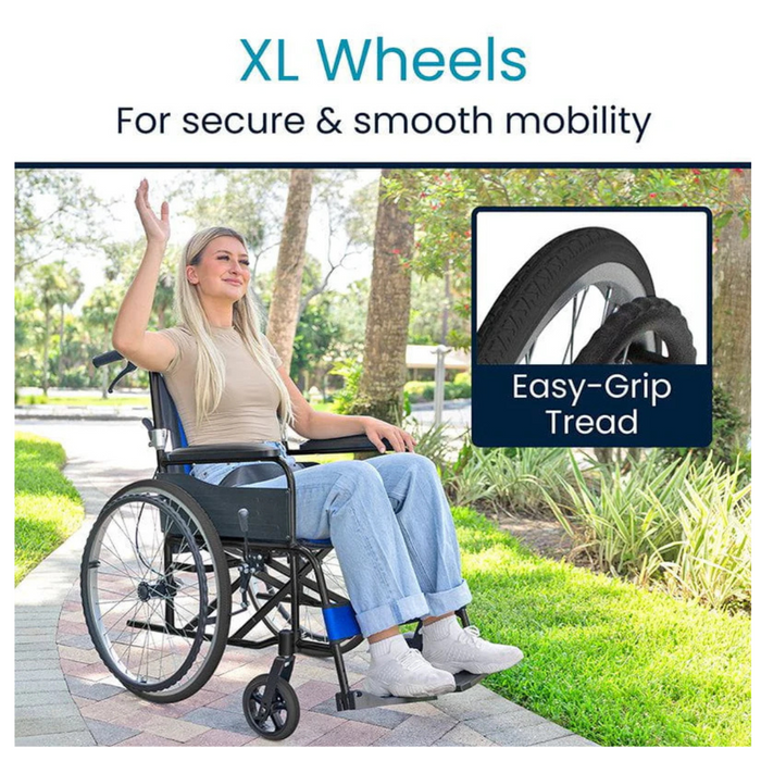 A woman in a wheelchair waves happily on a park path, wearing a beige top and blue jeans. The image showcases the XL wheels of the Vive Health Air Frame Lightweight Folding Wheelchair, designed with easy-grip tread for secure and smooth mobility.