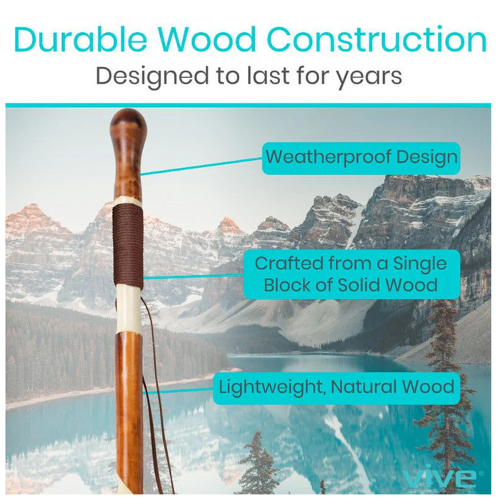 The Vive Health Carved Wooden Walking Stick is displayed against a mountainous backdrop, highlighting its weatherproof design, single block solid wood construction, non-slip rubber tip, and lightweight natural material.