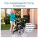 Wearing a turquoise top and beige pants, a woman walks outside with the 14.5 lbs Vive Health Carbon Fiber Euro-Style Rollator, featuring a pre-assembled frame, height-adjustable handles from 31 to 39 inches, and dimensions of 27.5 inches wide by 24 inches deep.