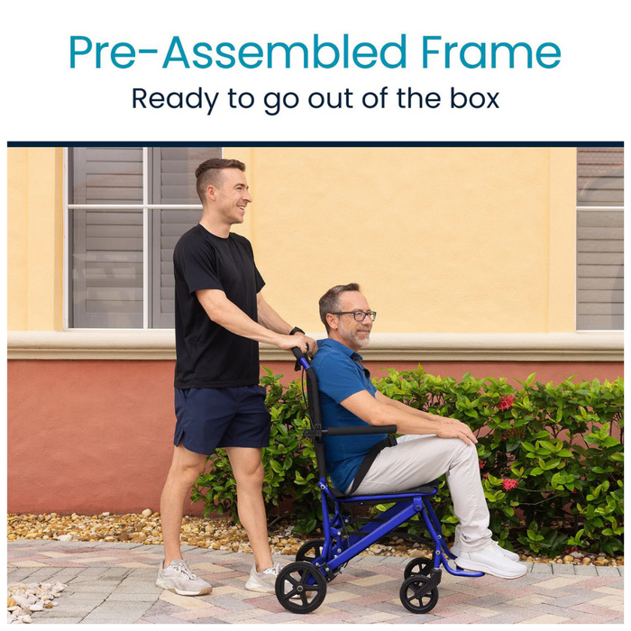 A person in a black shirt pushes another in a Vive Health Lightweight Transport Wheelchair along the sidewalk in front of a peach-colored building with nearby bushes. Text at the top reads Pre-Assembled Frame with Compact Design, Ready to go out of the box.