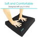 Two hands press on a Vive Health Wheelchair Gel Seat Cushion. The black cushion, with Vive printed on it, has a premium foam layer and is described as Soft and Comfortable, Designed with you in mind, offering back and tailbone pain relief.