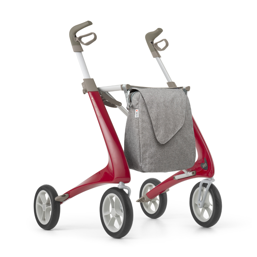 A stylish Weekend Bag designed for ByAcre Carbon Fiber Rollators is attached to a modern red and gray four-wheeled walker, offering convenient storage and enhancing mobility assistance with essential product features.