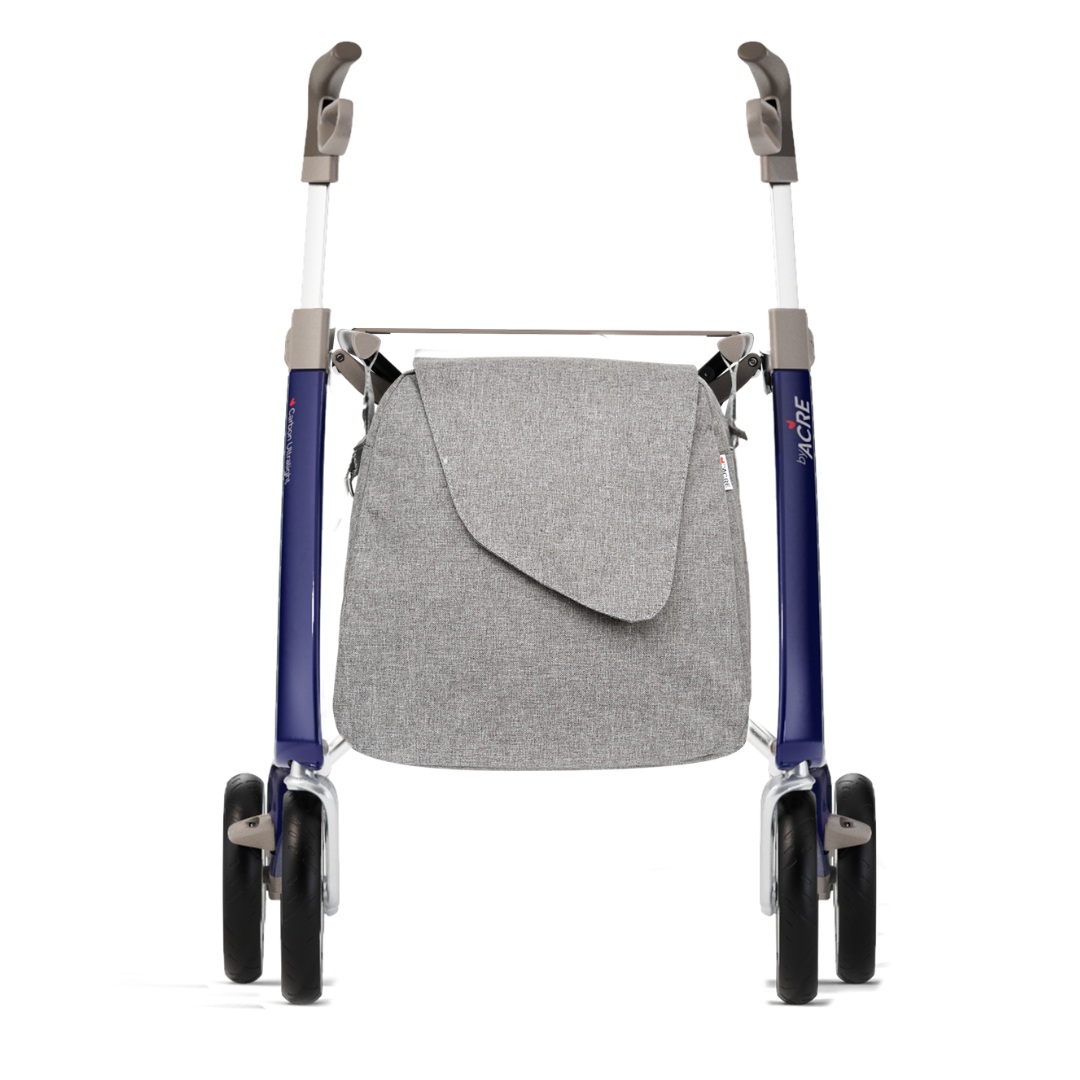 A Weekend Bag for ByAcre Carbon Fiber Rollators is shown attached to a rollator with four black wheels, a blue and white frame, and against a white background. See the spec-table for full product specifications.