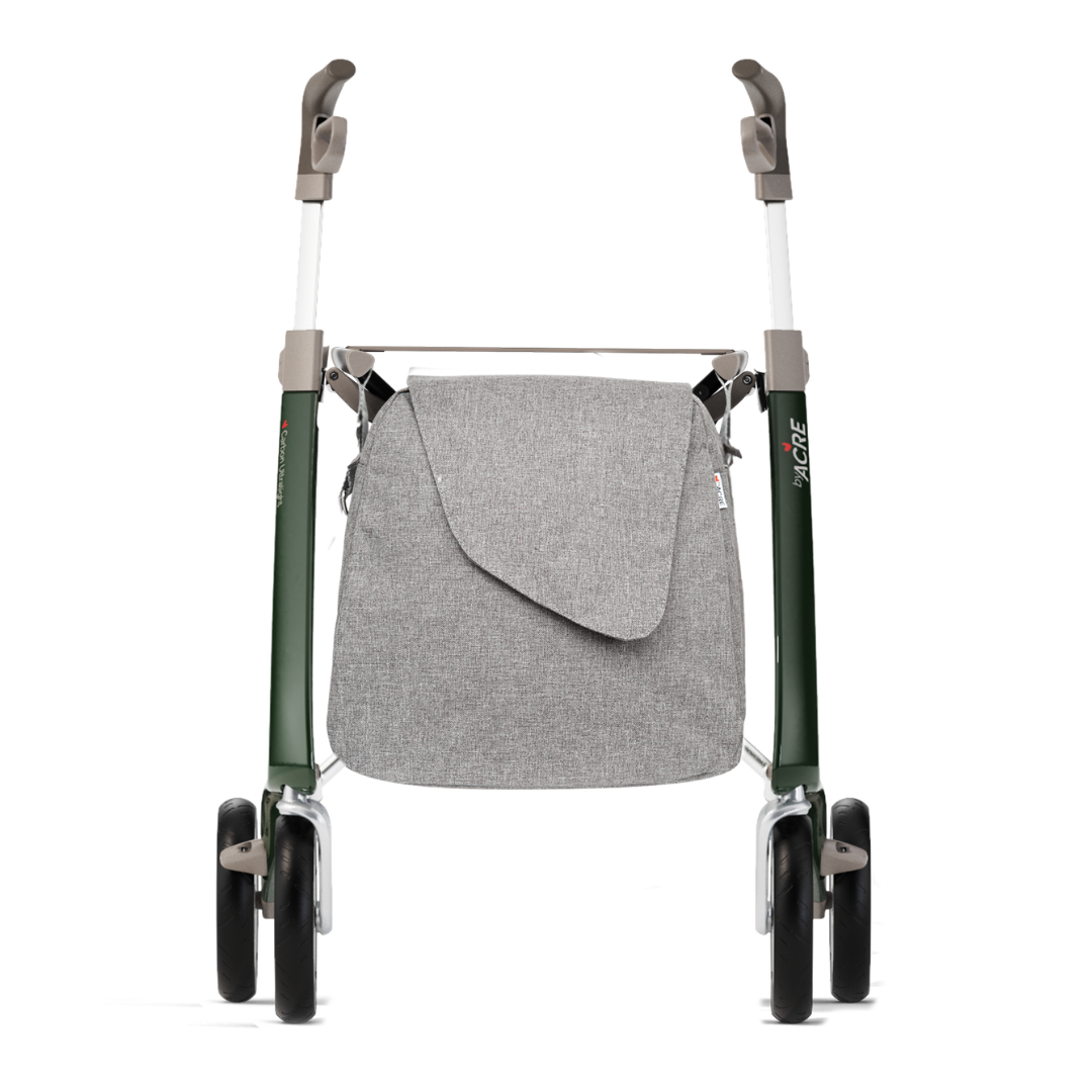 A front view of a green ByAcre Carbon Fiber Rollator with four black wheels and gray handles, featuring a light gray Weekend Bag attached to the front with a flap closure and thoughtful table design features.