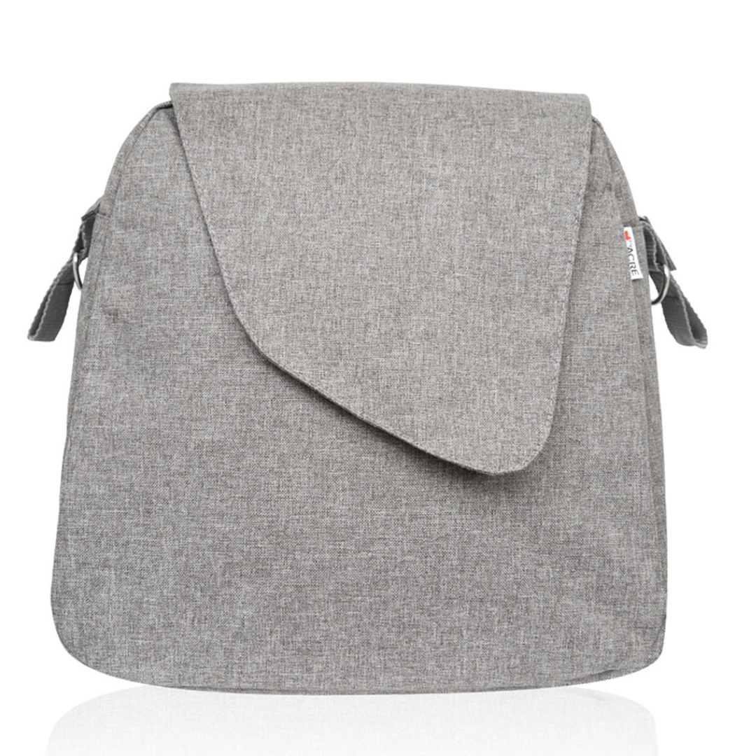 A Weekend Bag for ByAcre Carbon Fiber Rollators, made of gray fabric with an asymmetrical front flap and side straps, is displayed upright against a white background, reflecting sleek modern table design elements.