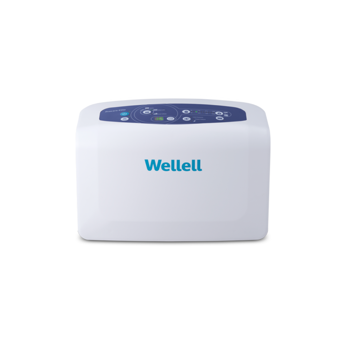 The Wellell Procare Elite Alternating Pressure Mattress with Micro Low Air Loss is a white rectangular device with a blue digital control panel on top and the Wellell logo, designed to help prevent pressure injuries.