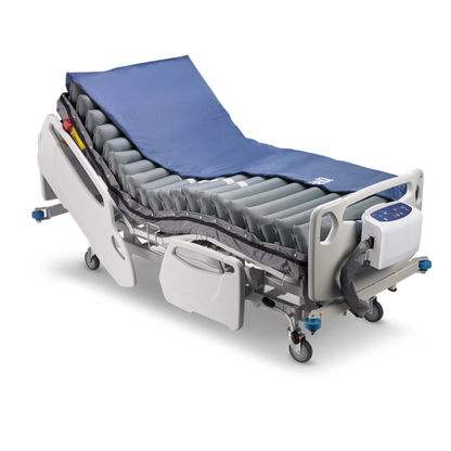 The Wellell Procare Elite Alternating Pressure Mattress with Micro Low Air Loss features a blue cover, side rails, and a foot-end control panel—designed for comfort and effective pressure injury prevention on hospital beds.