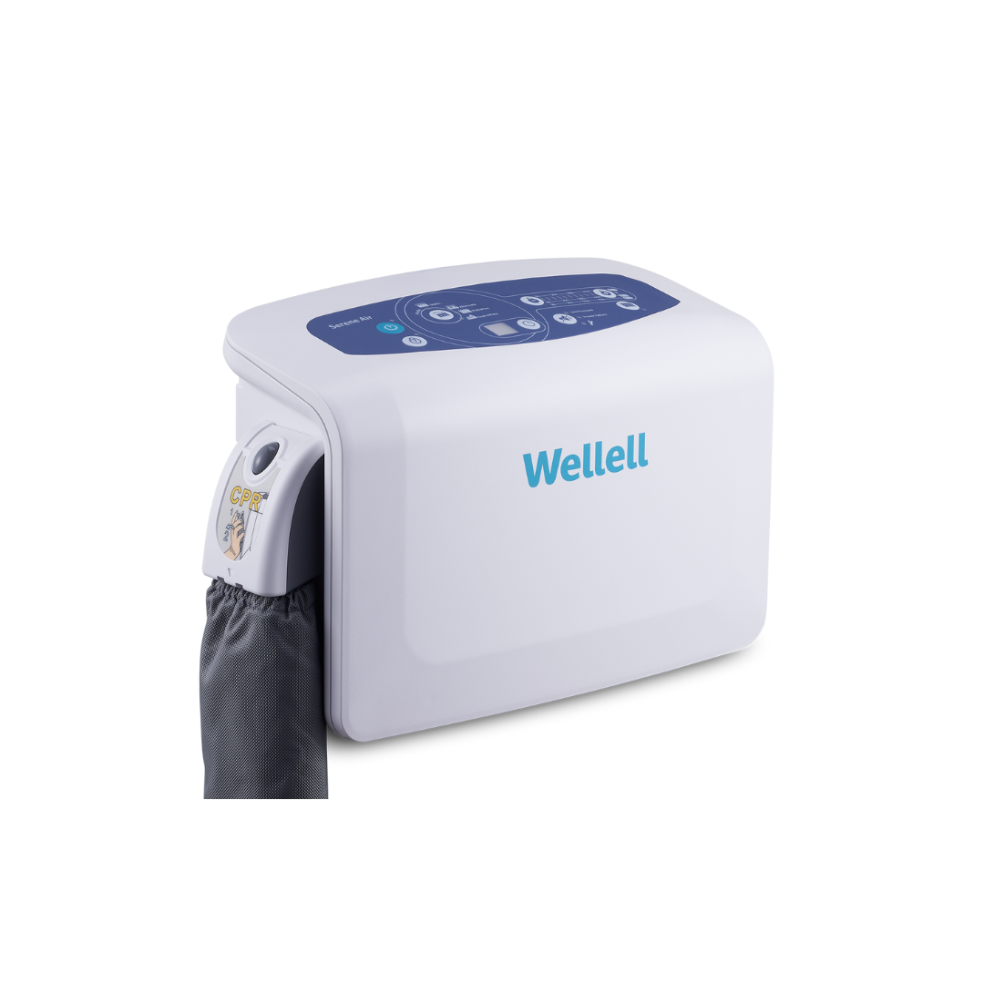 The Wellell Serene Air Alternating Pressure Mattress with True Low Air Loss is a white medical device with a digital control panel and gray fabric sleeve, designed to help prevent pressure injuries in post-acute care settings.