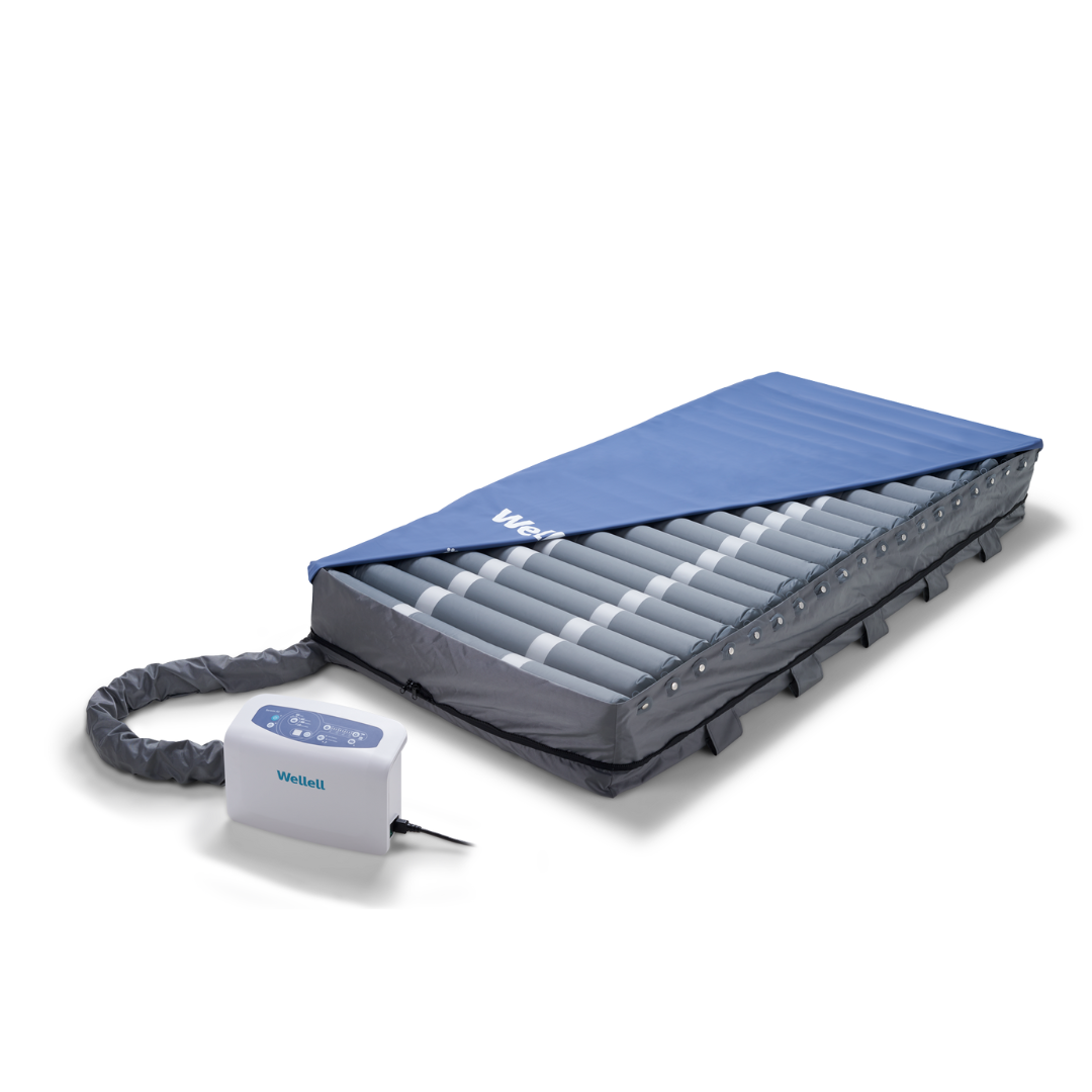 The Wellell Serene Air Alternating Pressure Mattress with True Low Air Loss features alternating pressure tubes, a blue cover, and an electronic control unit for effective pressure injury prevention.