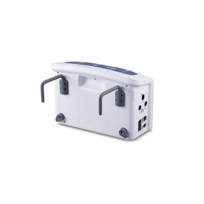 The Wellell Serene Air Alternating Pressure Mattress with True Low Air Loss is a white medical device with two gray foldable handles, four rubber feet, and multiple ports and buttons on its panel for pressure injury prevention.