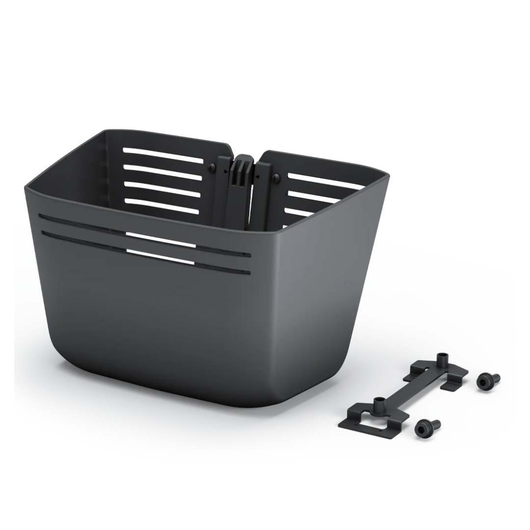 The Front Basket for Whill Model R scooters is a black plastic storage basket with horizontal slits, shown with two mounting brackets and two screws on a white background—an ideal accessory for added convenience.
