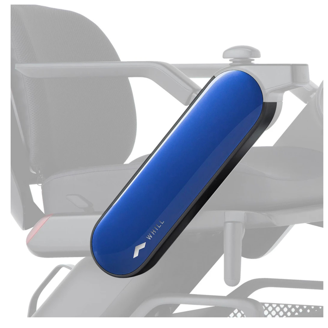 A close-up of a blue Arm Cover for WHILL Model C2 Power Chairs, featuring the WHILL logo; the interchangeable cover customizes your chair, while the rest of the wheelchair appears in grayscale in the background.