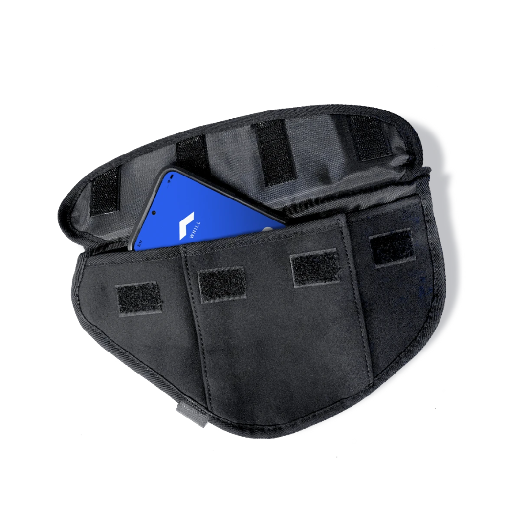 The Side Bag for Whill C2 & F Model Power Chairs is a black fabric pouch with Velcro closures, shown open with a blue device inside—ideal for convenient storage as a mobility accessory or wheelchair armrest bag.