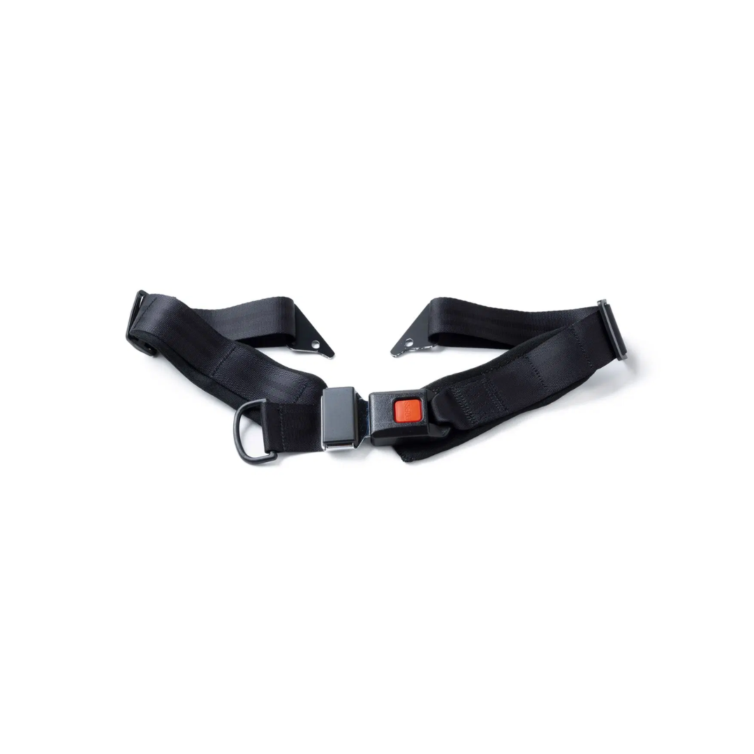 The Lap Belt For The Whill C2 Power Chair is black, features a metal buckle with an orange release button, and is shown laid flat on a white background. Compatible with the WHILL Model C2.