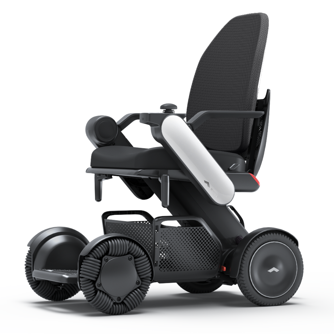 The Whill Model C2 High Back Smart Power Chair with RC App Control features a sleek black design, high backrest, and rugged wheels for superior mobility and comfort, blending advanced style and functionality in one modern package.