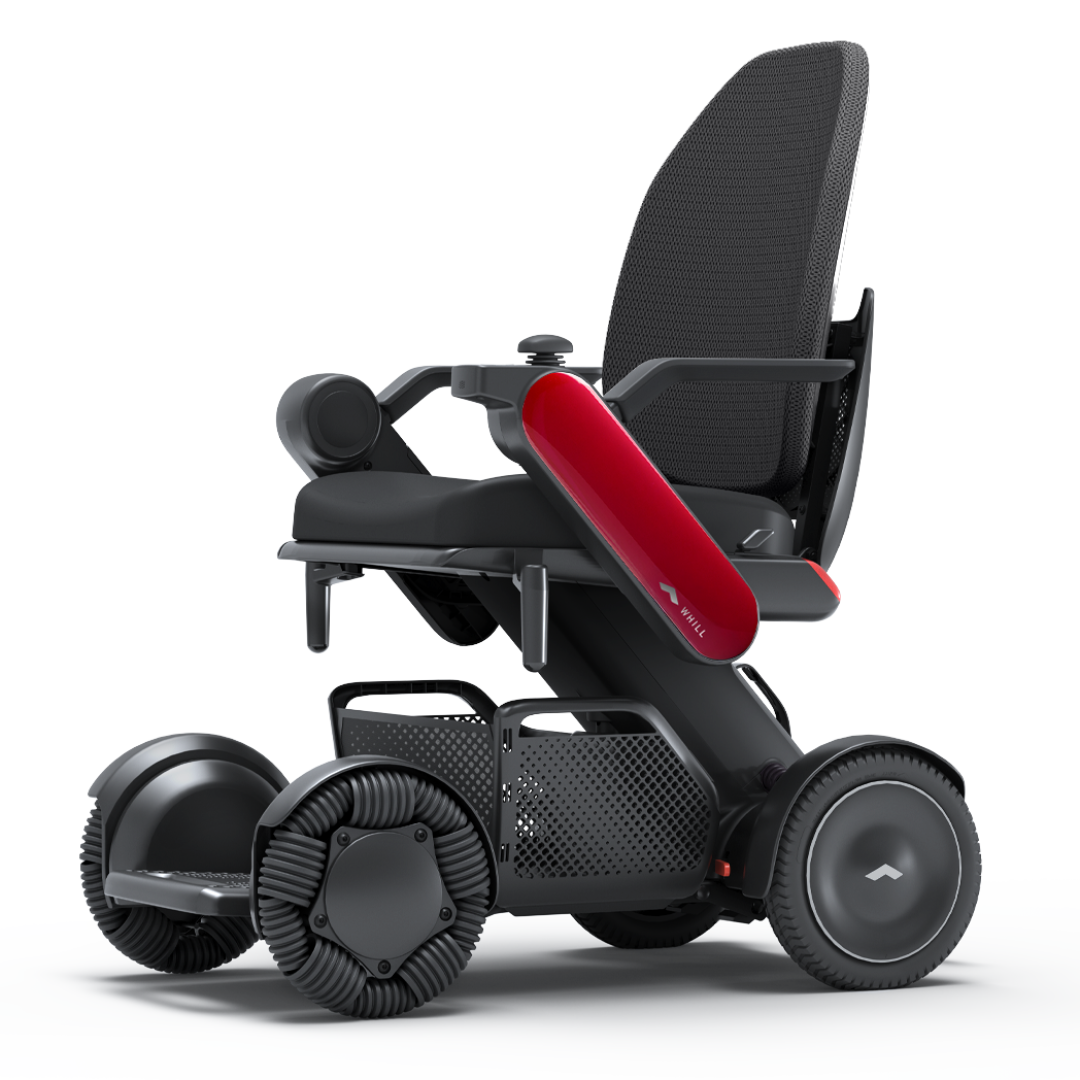 The Whill Model C2 High Back Smart Power Chair with RC App Control boasts a sleek black frame, large textured wheels, mesh backrest, and striking red armrest accent—offering advanced maneuverability and modern style.