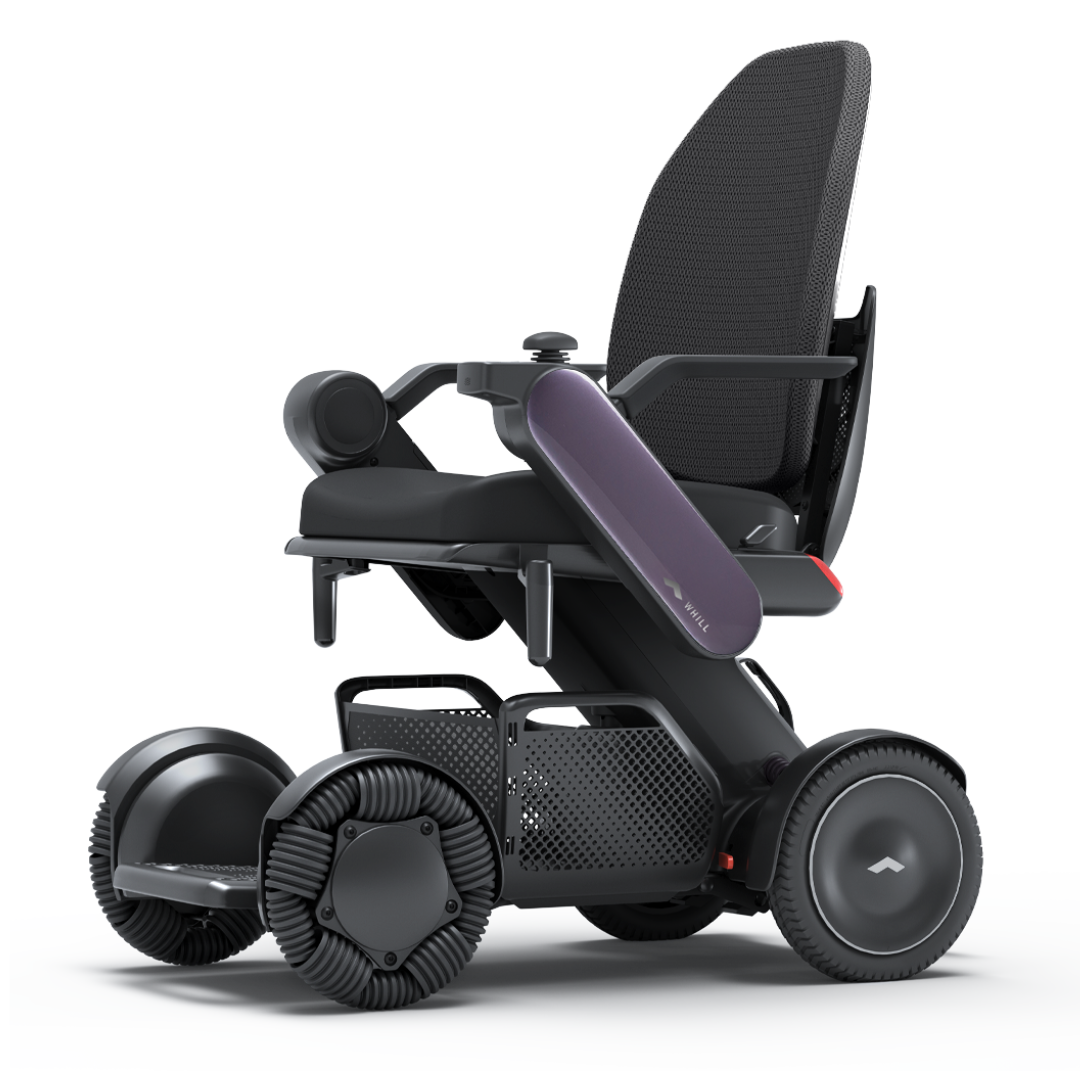 The Whill Model C2 High Back Smart Power Chair with RC App Control features a sleek black design, large omni-directional wheels, and a mesh backrest for comfort and mobility. Advanced tech ensures smooth navigation on any terrain.